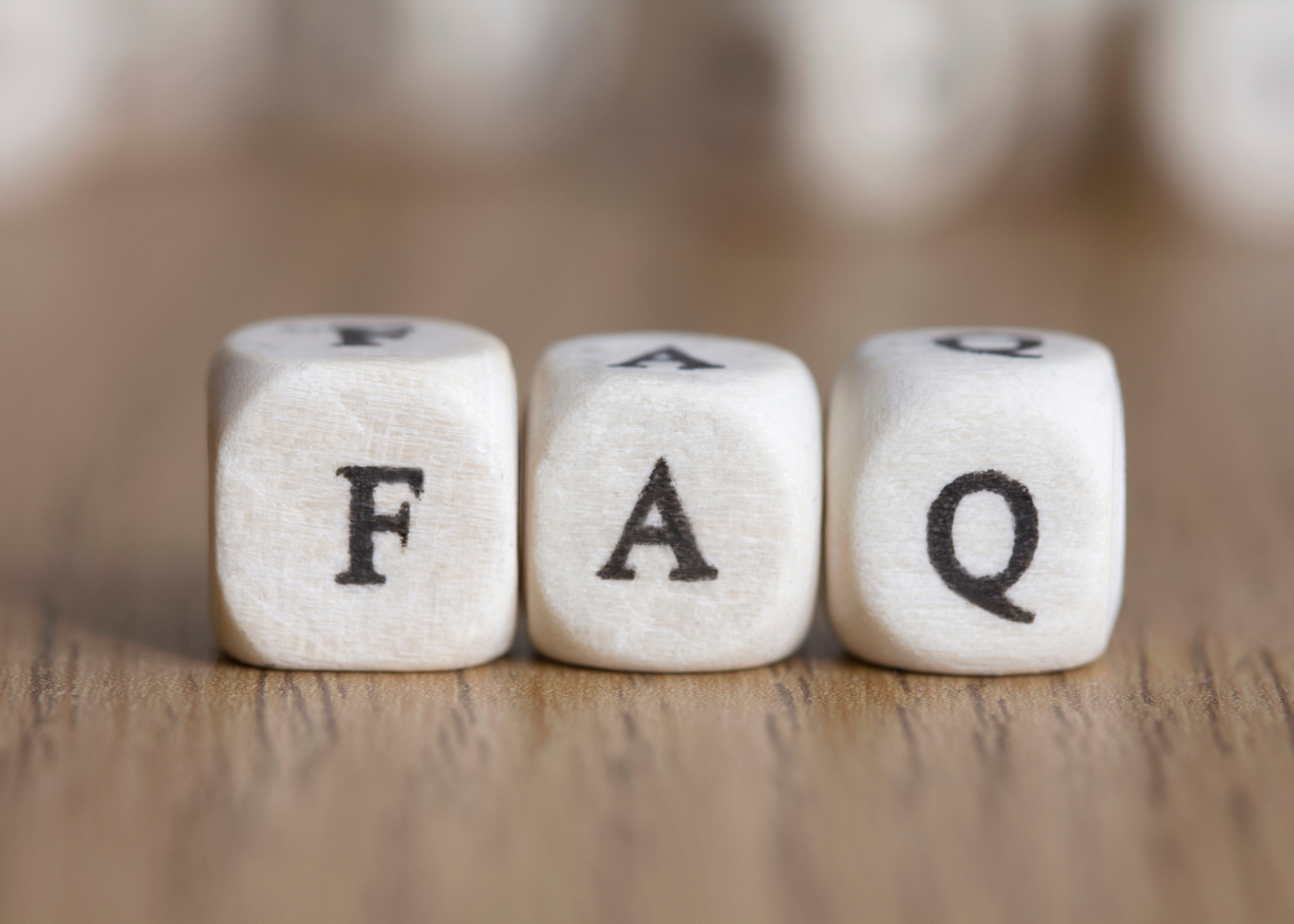 FAQ text written on 3 wooden dices